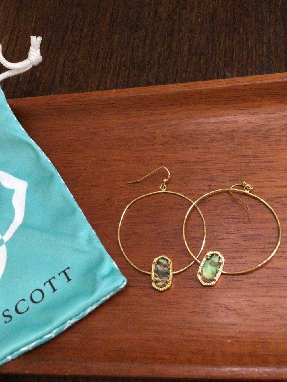 Kendra Scott hoop earrings with an abalone glass stone trimmed in goldtone